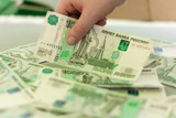 Fototapeta  - money, Russian thousand bills on the table, children's hand takes the bill in hand