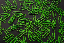 Pile Of Green Paperclips On Black Table, Office Supplies Background