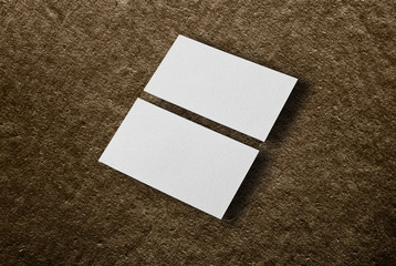 Mockup of two horizontal business cards at brown background.