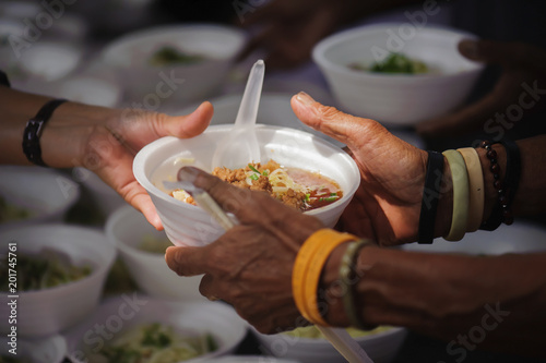 Fotomural Feeding the poor to hands of a beggar. Poverty concept
