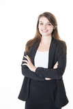 Fototapeta Na sufit - formally dressed business woman looking into the camera with her arms crossed while standing in front of white background