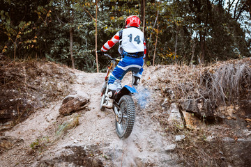 Trials motorcycle while competition in nature park