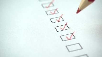 Poster - A person checking off a to do list with red pencil. Check all the boxes of a checklist, close-up, 4k