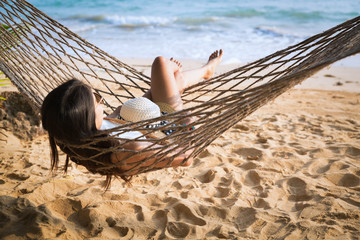 Wall Mural - Happy woman relaxing in hammock