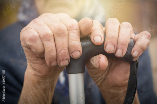 Fotografie, Obraz close-up of old dirty wrinkled woman hands holding walking stick