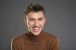© Yakobchuk Olena - Portrait of cheerful man in pullover staring and laughing. Isolated on background