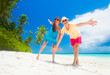 © el.rudakova - happy young couple with beach accessories having fun by the beach
