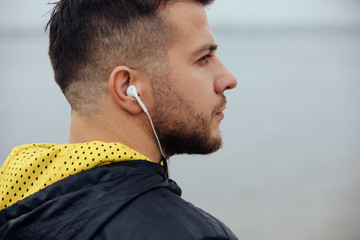 Wall Mural - Sportsman listening to music in earphones