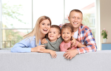 Wall Mural - Happy family on sofa at new home