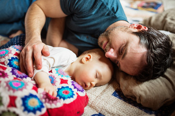 Wall Mural - Father with a baby girl at home sleeping.