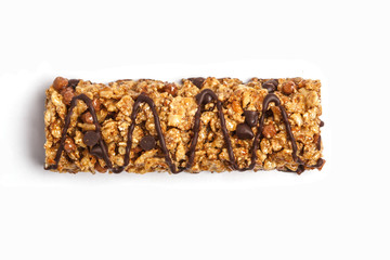 Wall Mural - Chocolate granola bar isolated on white background. Healthy sweet dessert snack. Cereal granola bar with nuts, chocolate  and berries on a white background. Top view copy space.