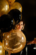 Happy Girl with Balloons and Champagne. Great Copy Space for Golden Text