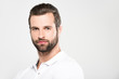 © LIGHTFIELD STUDIOS - portrait of handsome bearded man looking at camera, isolated on grey
