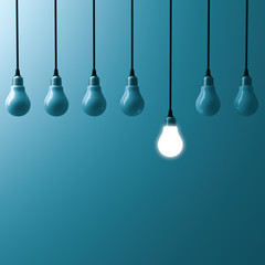 Fototapete - One hanging light bulb glowing and standing out from unlit bulbs on dark blue green color background. 3D rendering.