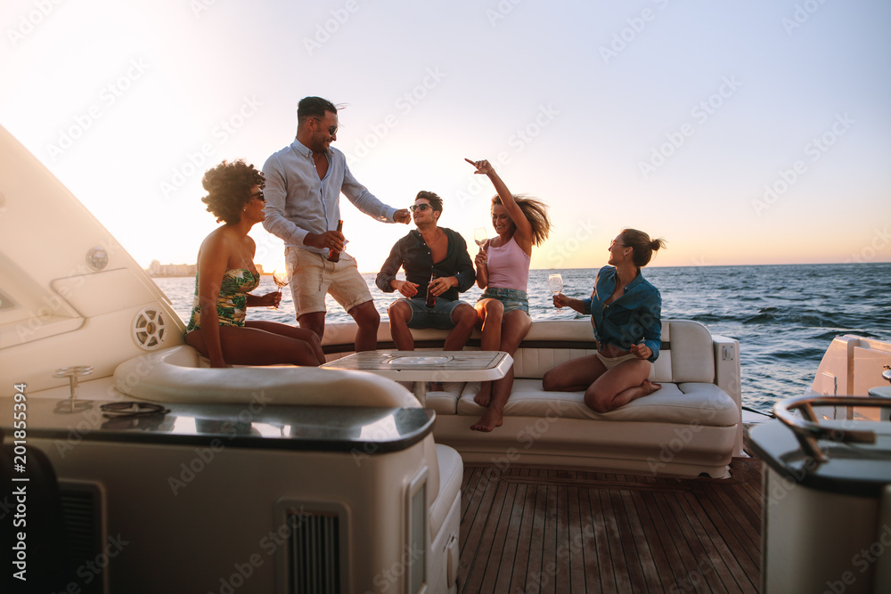 Group of friends enjoying in a boat party - obrazy, fototapety, plakaty 