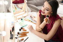 Portrait Of Beautiful Woman Applying Makeup Indoors