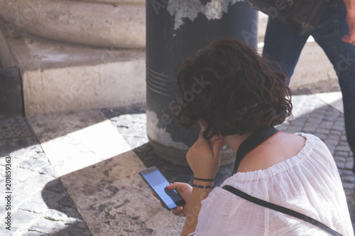 rear view of woman using smartphone Poster Mural XXL