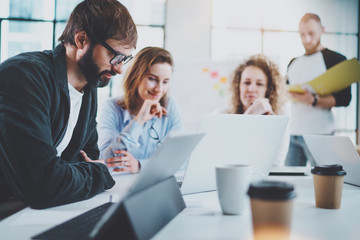 Happy business team making conversation at sunny meeting room.Horizontal.Blurred background.