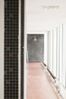 White interior corridor with tile floor and walls