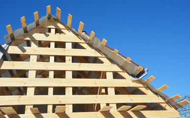 Wall Mural - House attic wooden roofing construction. Installing wooden rafters, logs, eaves, timber.