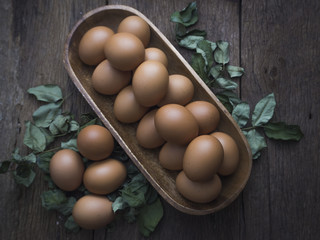 Fresh eggs in on old wooden background