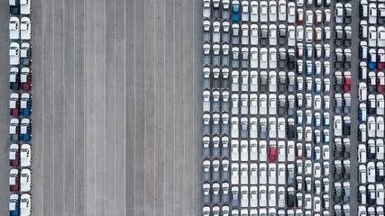 Wall Mural - Aerial top view new cars lined up in the port for import  export business logistic and transportation by ship in the open sea.