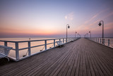 Fototapeta Pomosty - Amazing colorful sunrise over the pier in Gdynia Orlowo. Sunrise over the sea.
