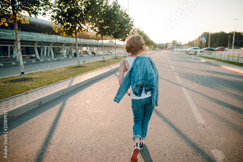 Back View Shot Of A Young Woman With Short Blonde Hair And Jeans