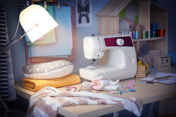 Poster - Sewing machine on table in workshop