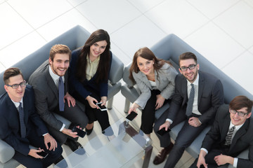 Wall Mural - Top view of beautiful young business  people in using smartphone