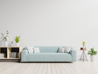 Empty living room with blue sofa, plants and table on empty white wall background. 3D rendering.