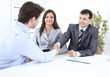 © ASDF - handshake business partners in the workplace