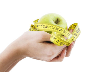 hands with fruit and tape measure, concept of diet and health