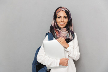 Poster - Portrait of a smiling young arabian woman student