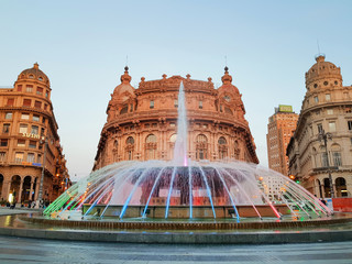 GENOVA (GENOA) ITALY - APRIL 16, 2018: Colorful fountain in evening time with beautiful building europe style in Piazza de Ferrari square in the city center of genova (genoa) italy.