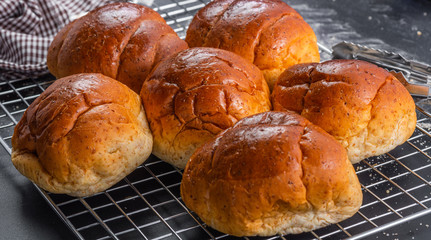 delicious bread on the mesh and black table, close-up