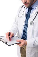 Wall Mural - Close-up view of doctor wearing white coat with stethoscope and writing in clipboard isolated on white