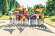 © william87 - Happy fans supporters with flags and multicolored t-shirts