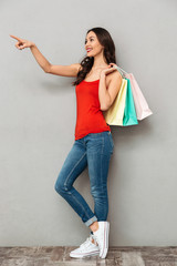 Sticker - Full length image of Cheerful brunette woman in casual clothes