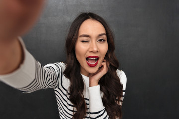 Poster - Happy brunette woman in sweater making selfie