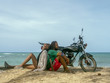 © Serge Touch - A man and a girl are traveling by motorcycle. Beach, sea