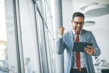 Wall Mural - Young businessman with digital tablet in office