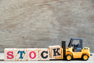 Canvas Print - Toy forklift hold letter block K to complete word stock on wood background