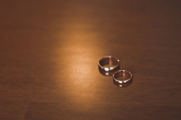 Wedding rings on a brown table 1144.