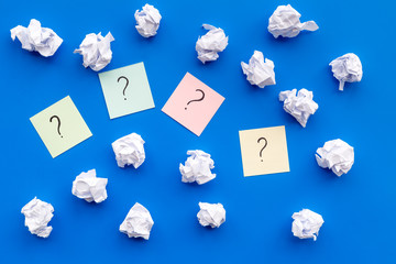 Poster - Question mark on sticky notes near crumpled paper on blue background top view