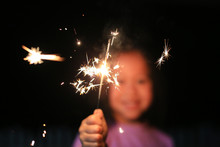 Little Asian Girl Playing Fire Sparklers In The Dark.