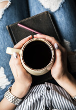 A Young Girl With A Beautiful Manicure Holds A Book With A Cup Of Coffee. Fashion Style