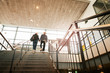 © Maskot - Low angle view of young couple moving on staircase at subway station