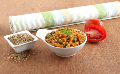 Wall Mural - Kodo millet and tomato pilaf, a healthy Indian vegetarian breakfast or lunch, which also has vegetables like peas, carrot, capsicum and onion.