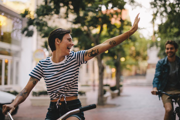 Couple enjoying cycling through city